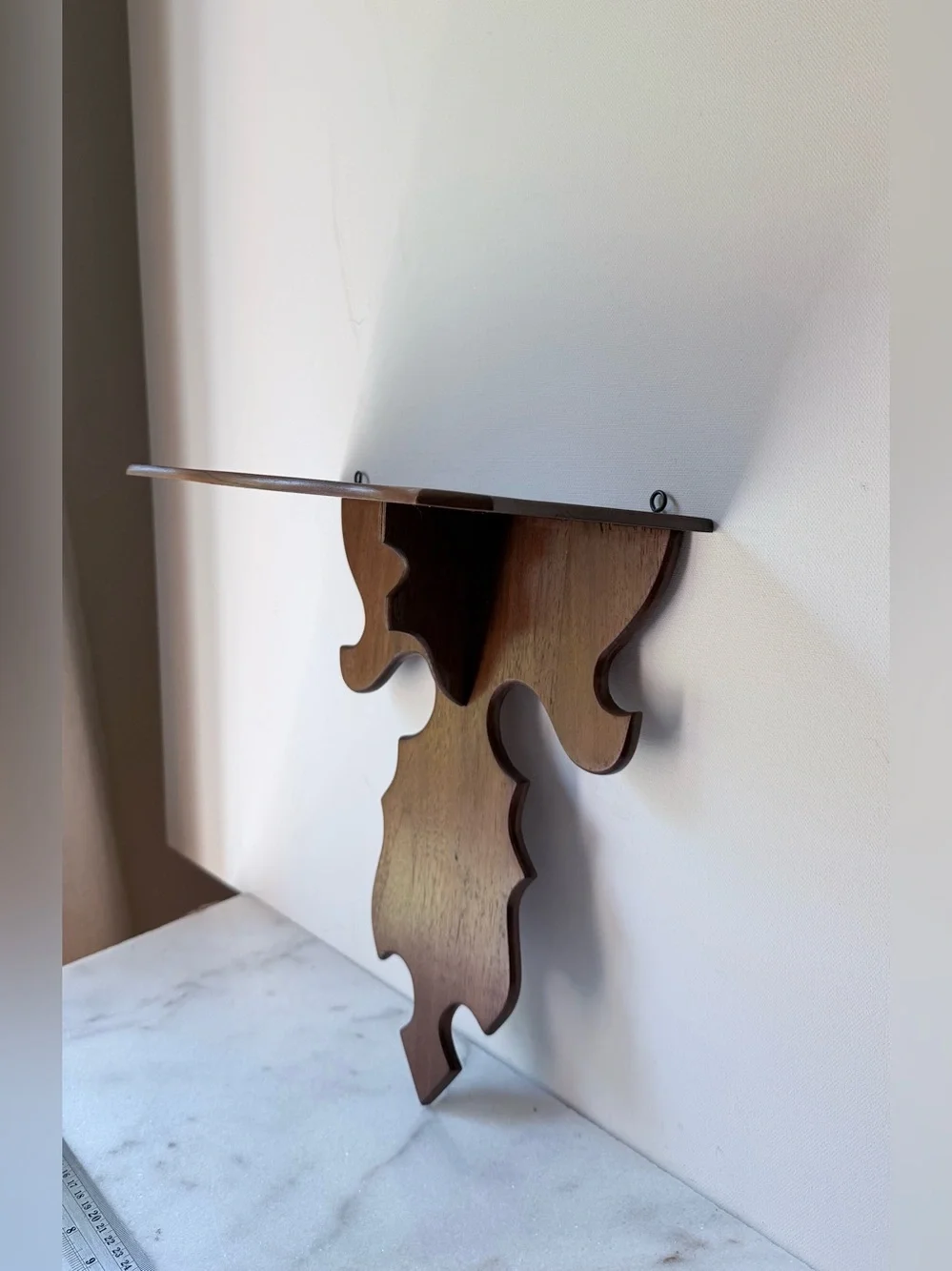 vintage wall sconce shelf made of carved wood with a dark finish